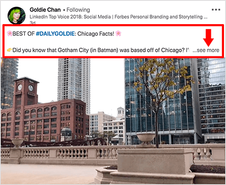Šis ir Goldie Chan LinkedIn videoklipa ekrānuzņēmums. Sarkanās norādes attēlā izceļ to, kā teksts parādās virs video ziņām LinkedIn ziņu plūsmā. Virs videoklipa parādās divas teksta rindas, kam seko trīs punkti un saite “Skatīt vairāk”. Tekstā teikts: “BEST OF #DAILYGOLDIE: Chicago Facts! Vai zinājāt, ka Gotemas pilsēta (Betmens) atrodas Čikāgas tuvumā.. . “Videoklipā redzamas ēkas Čikāgas centrā gar Čikāgas upi.